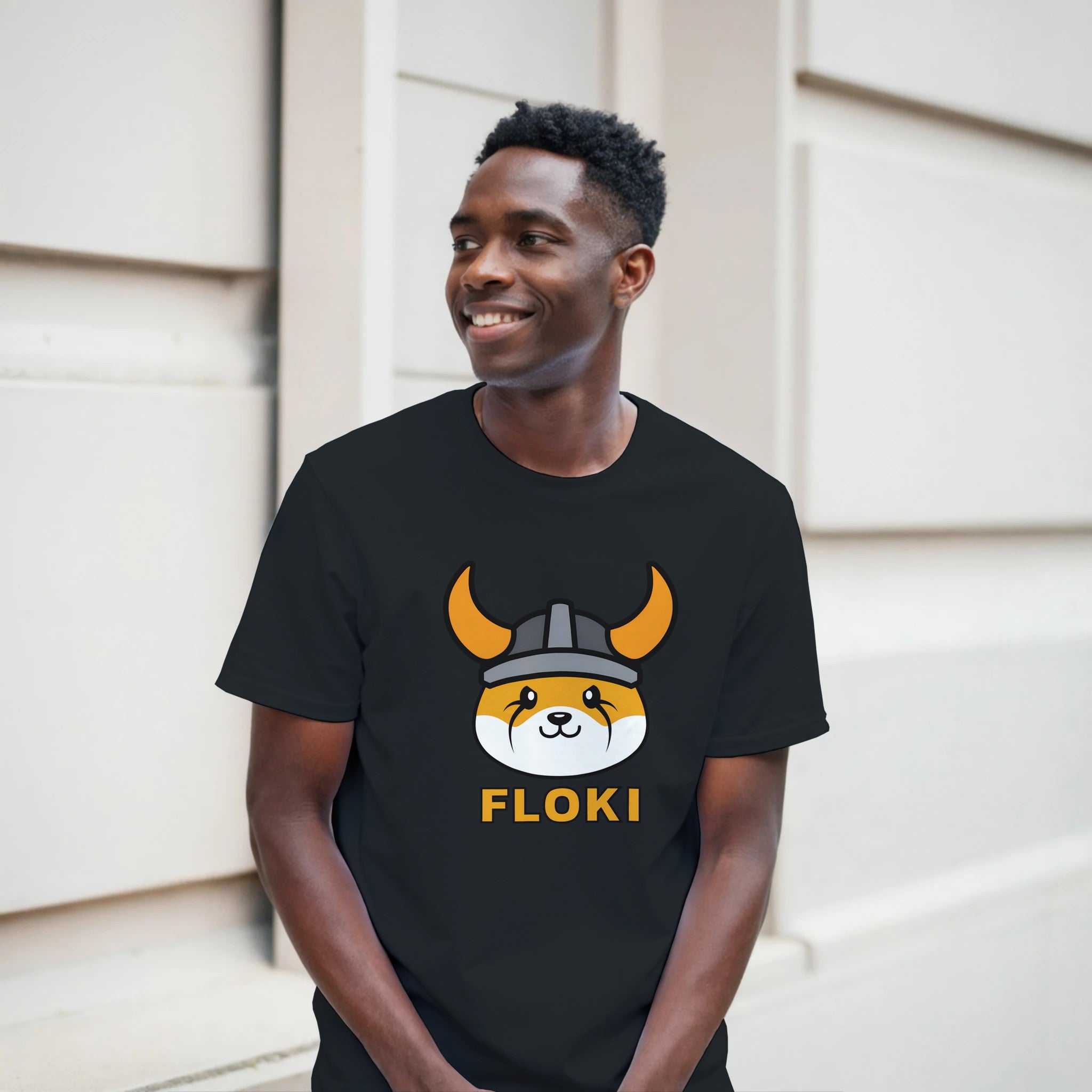 Person wearing a black t-shirt with a graphic design and text, standing outdoors.