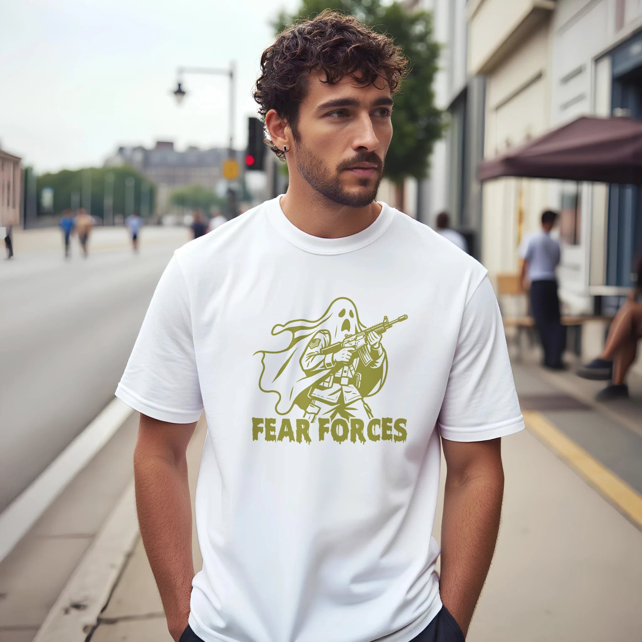 Man wearing a white t-shirt with 'Fear Forces' graphic design on a city street.