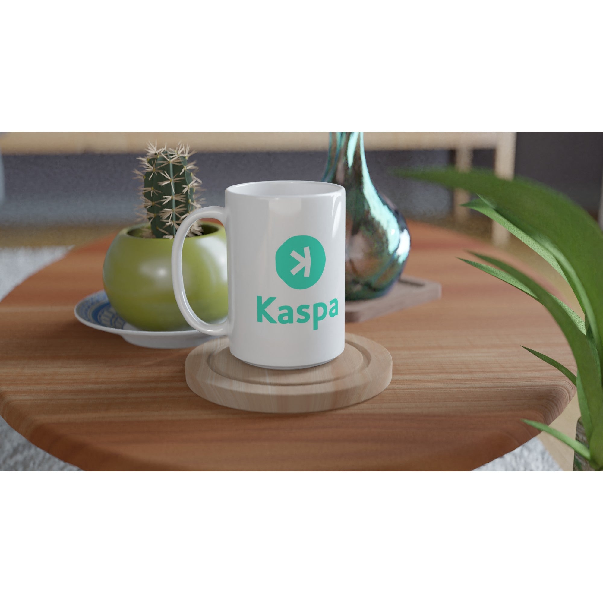 White mug with 'Kaspa' branding on a wooden table with decorative items.