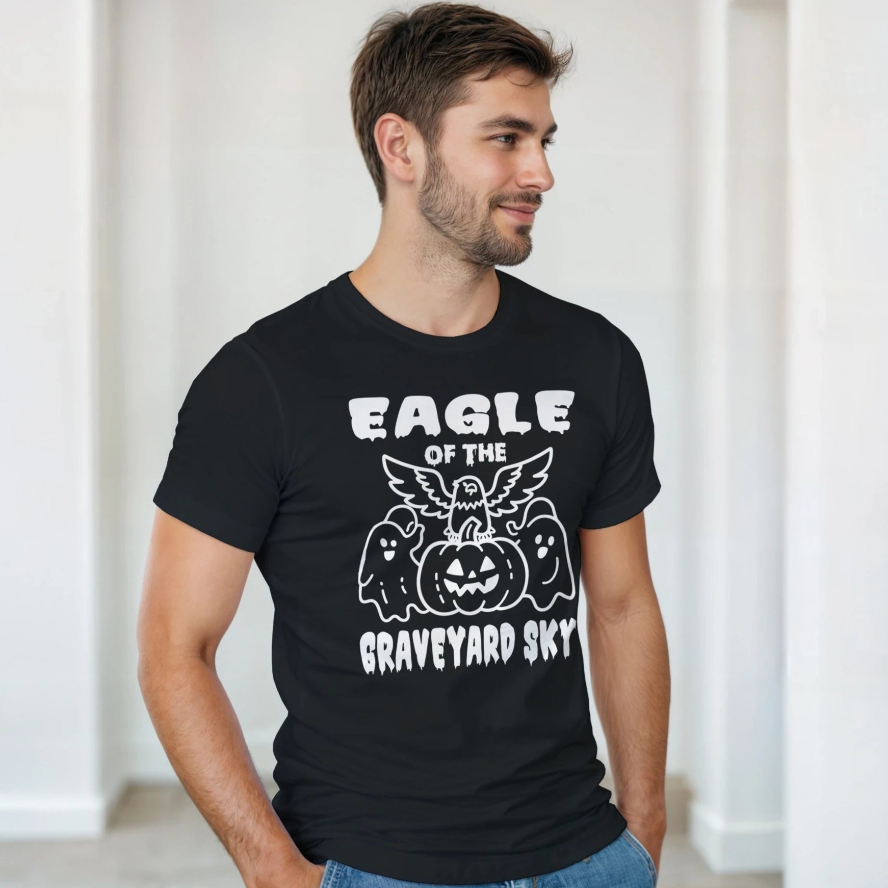 Man wearing a black t-shirt with a graphic design and text indoors