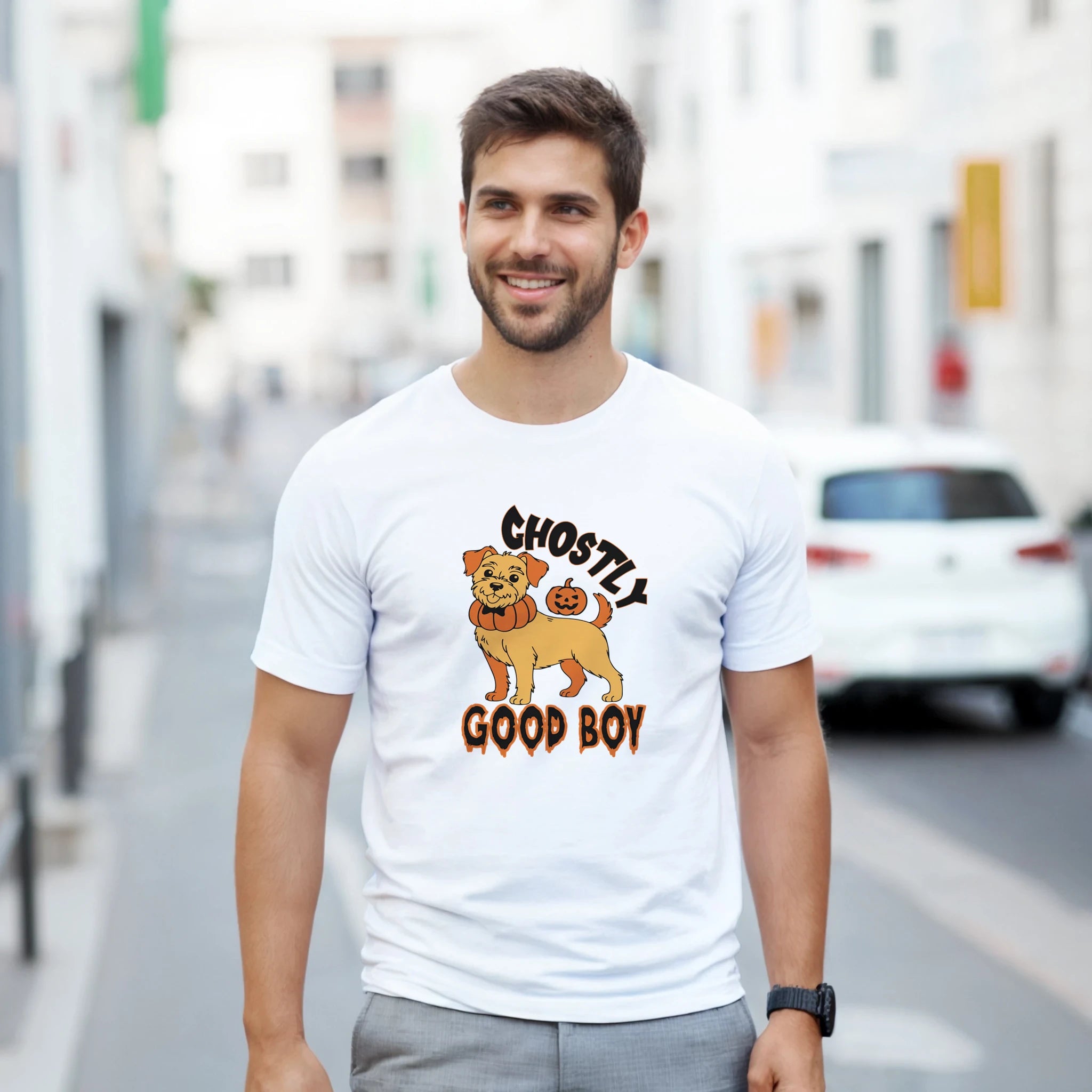 Man wearing a white t-shirt with a graphic design of a dog and text on a city street.