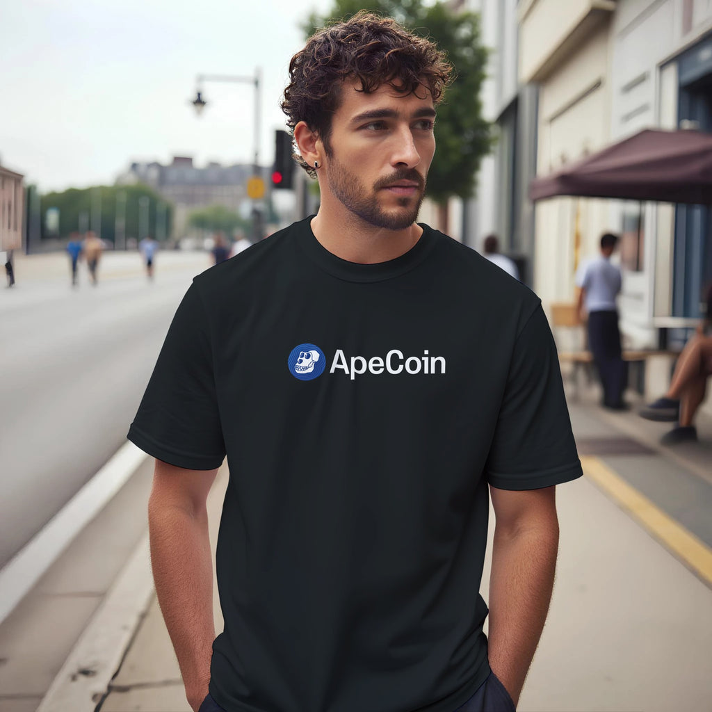 Man wearing a black t-shirt with ApeCoin logo on a city street
