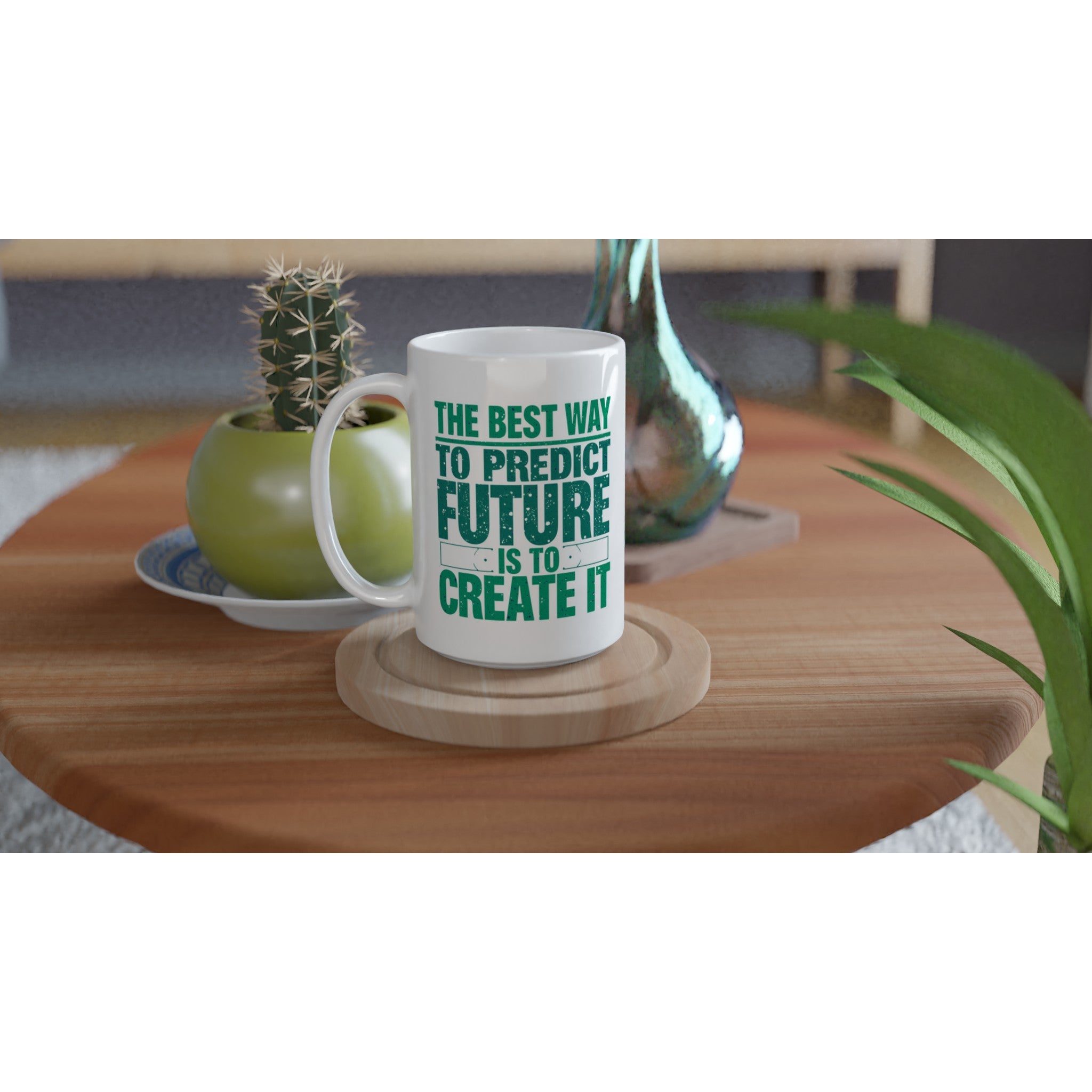 White mug with green text on a wooden table with plants