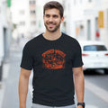 Man wearing a black t-shirt with red graphic design on a city street