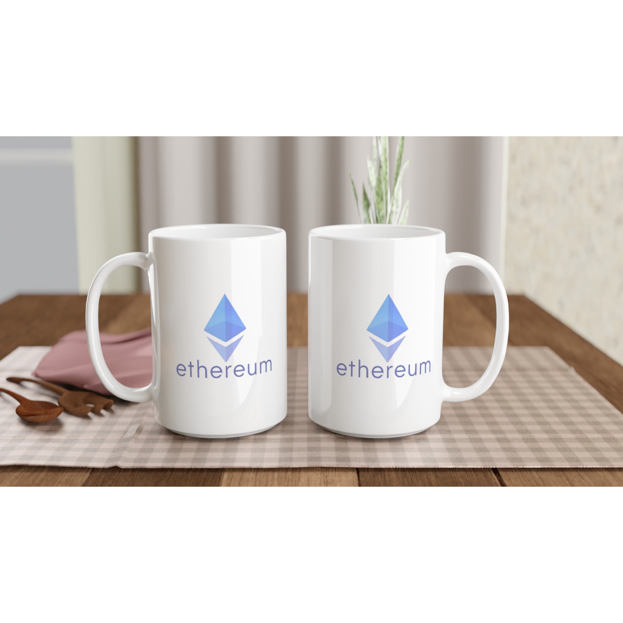 Two white mugs with Ethereum logo on a wooden table with a checkered tablecloth.