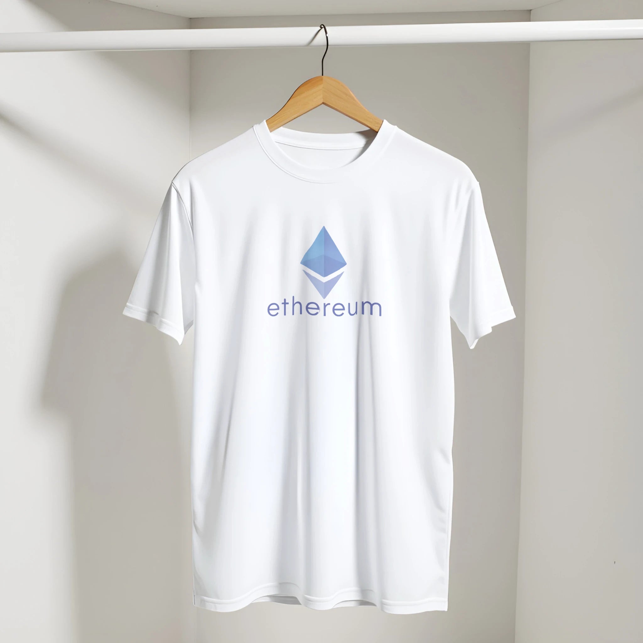 White t-shirt with Ethereum logo on a hanger against a plain background