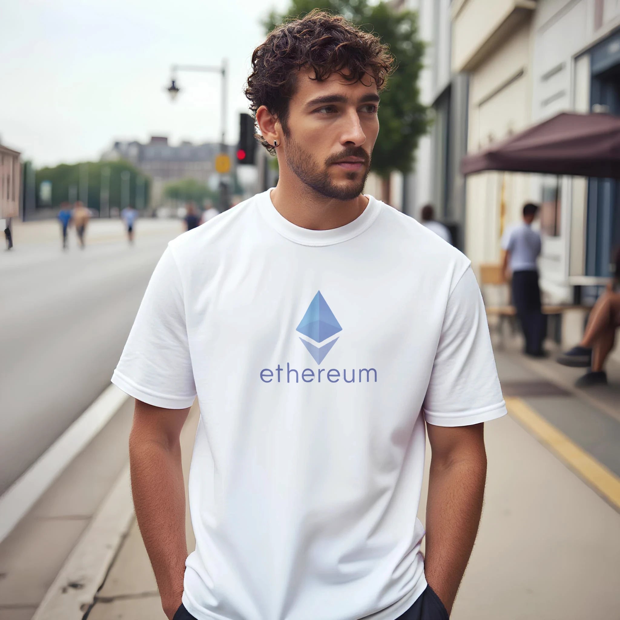 Man wearing a white t-shirt with Ethereum logo on a city street