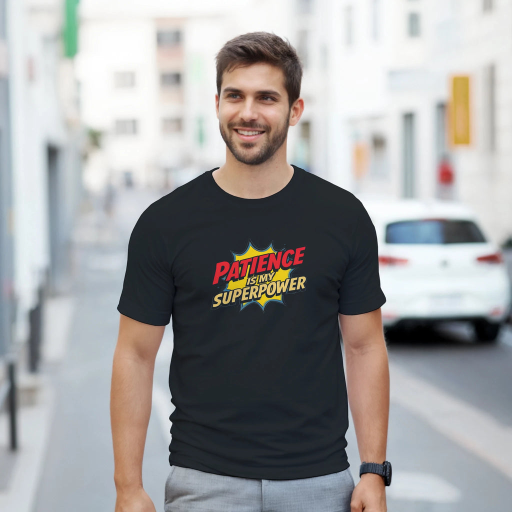Man wearing a black t-shirt with a colorful graphic and text on a city street.