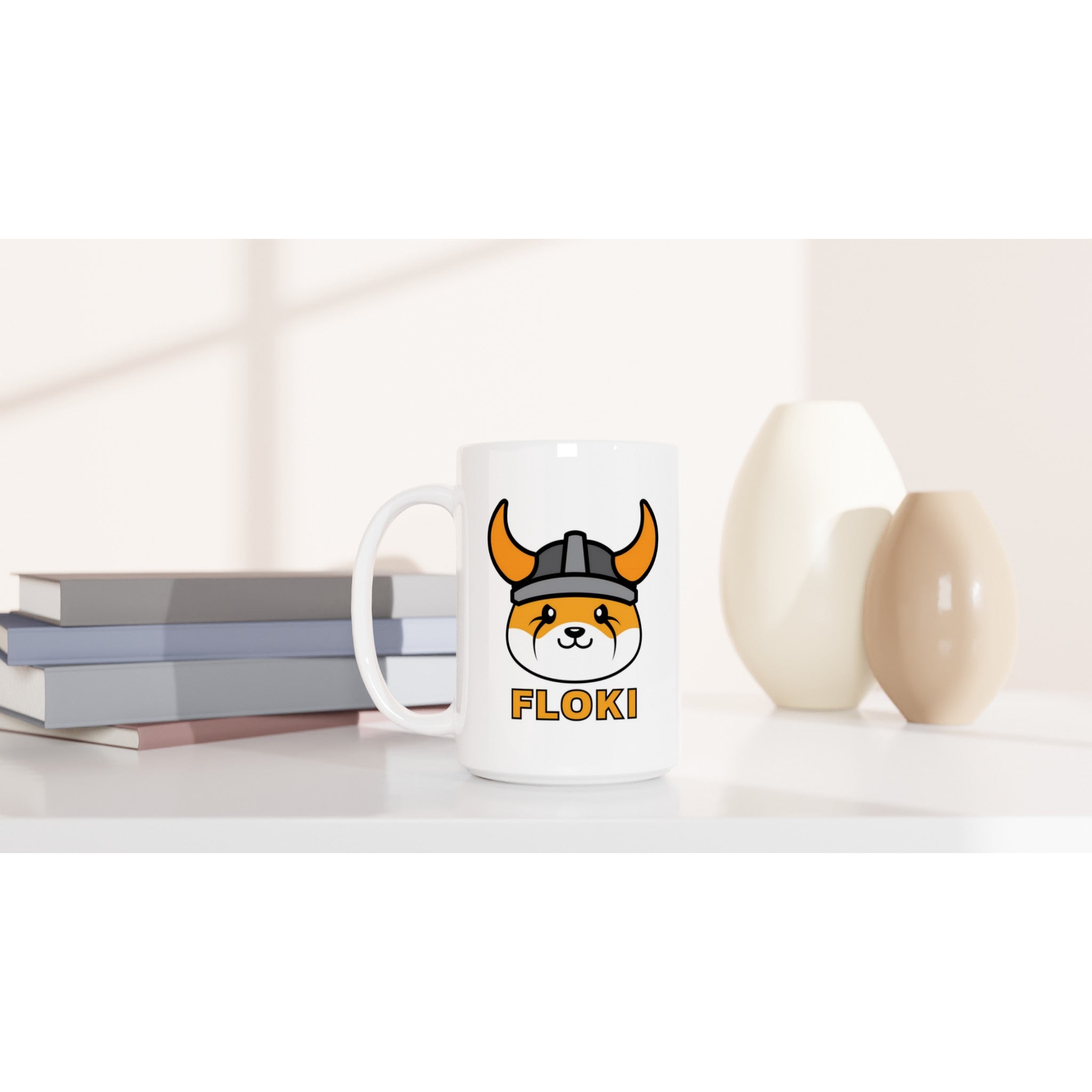 White mug with a dog logo and 'FLOKI' text on a white surface with books and decorative items.
