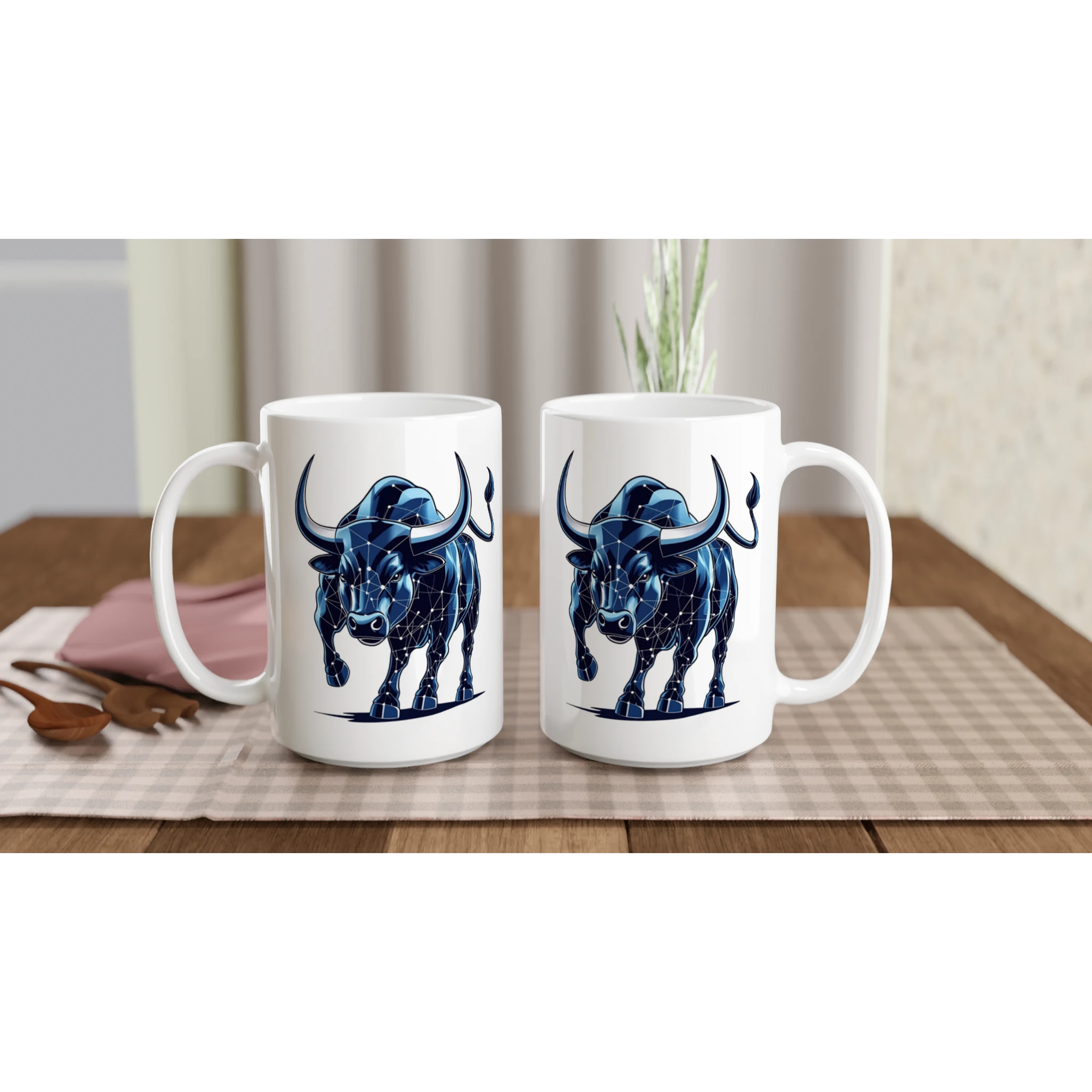 Two white mugs with blue bull designs on a wooden table.