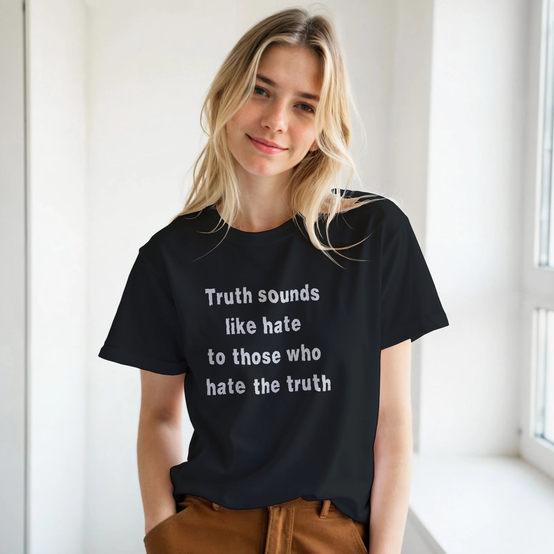 Person wearing a black t-shirt with a quote, standing indoors.