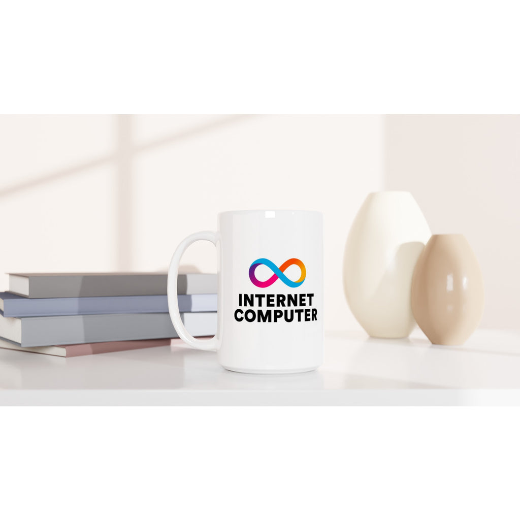 White mug with 'Internet Computer' logo on a white surface with books and decorative items.