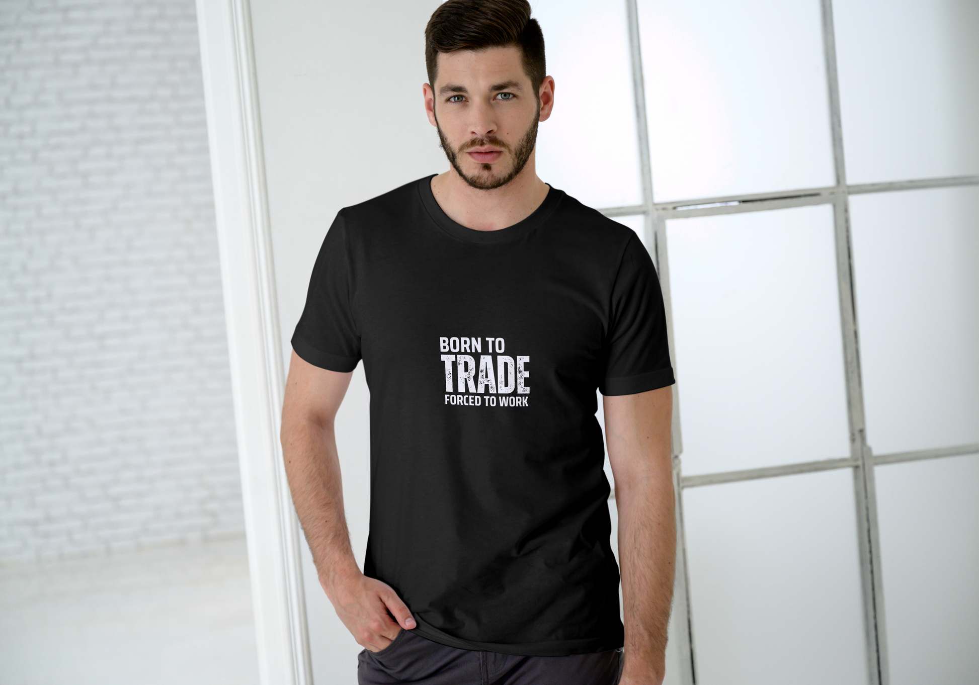 Man wearing a black t-shirt with text, standing against a light background