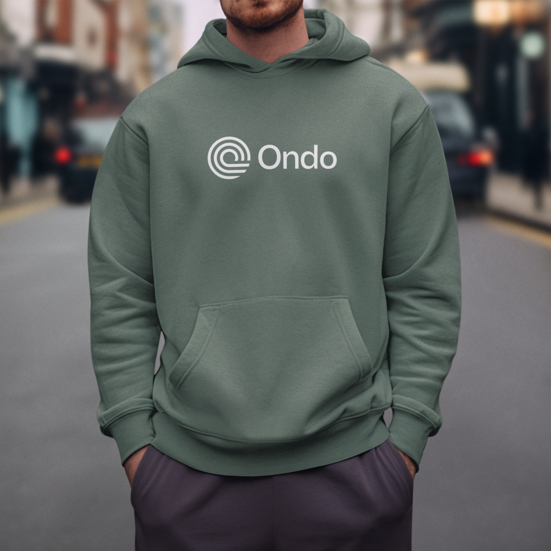 Person wearing a green hoodie with 'Ondo' logo on a city street