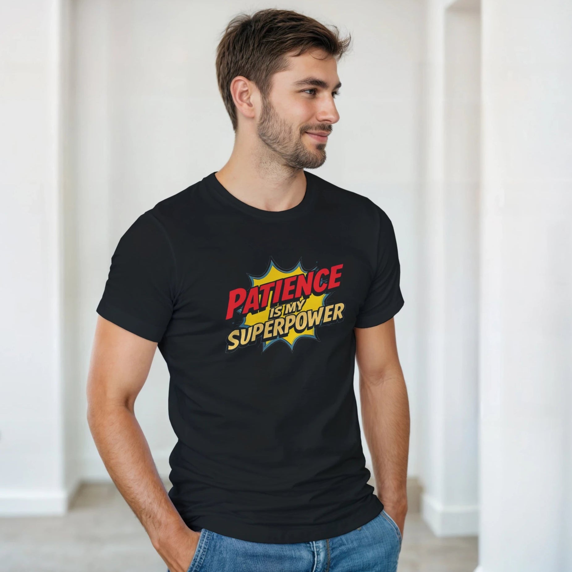 Man wearing a black t-shirt with 'Patience is my Superpower' design in a room.