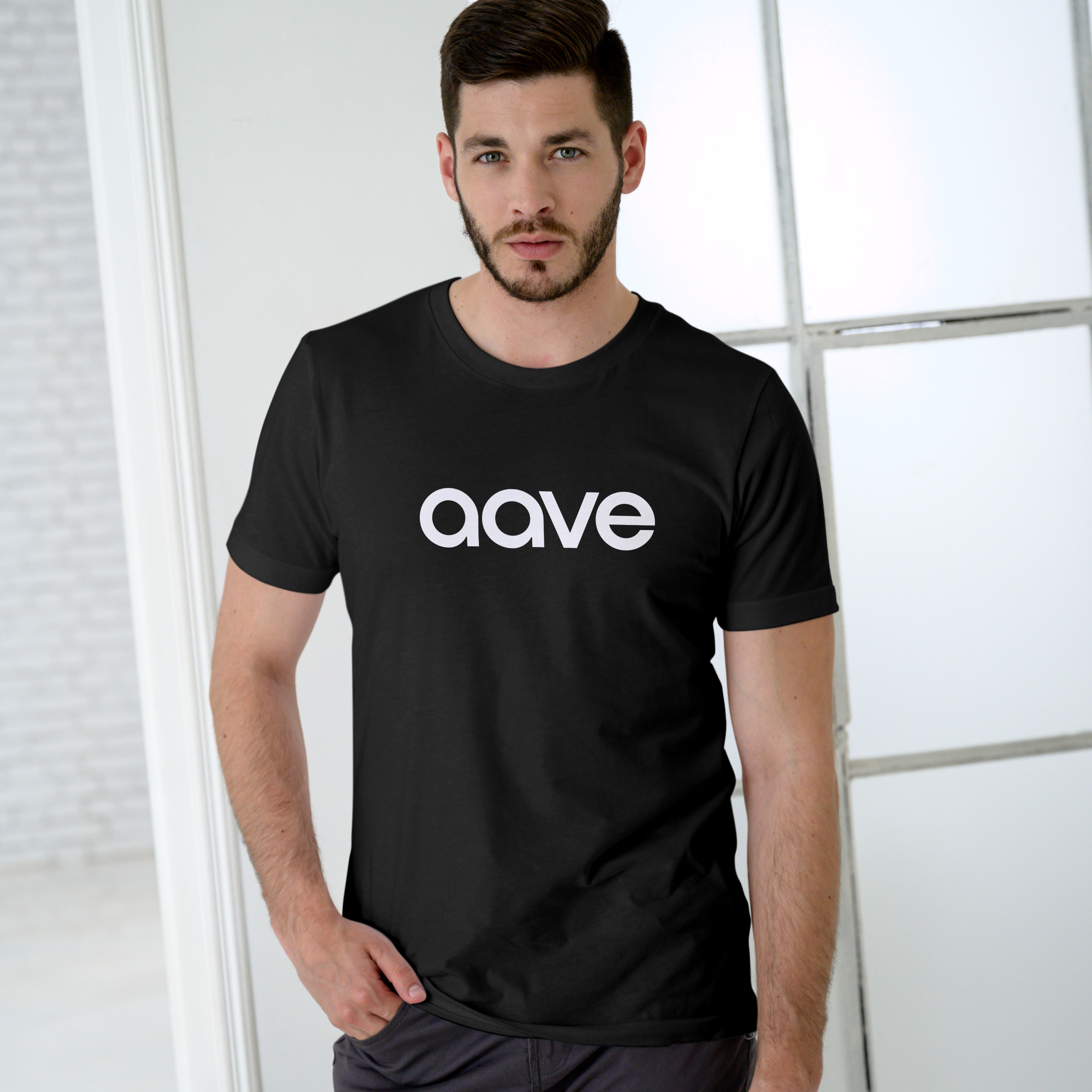 Man wearing a black t-shirt with 'aave' logo against a light background