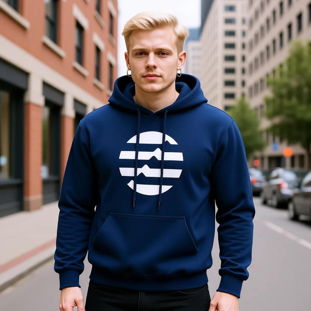 Man wearing a blue hoodie with a white logo on a city street