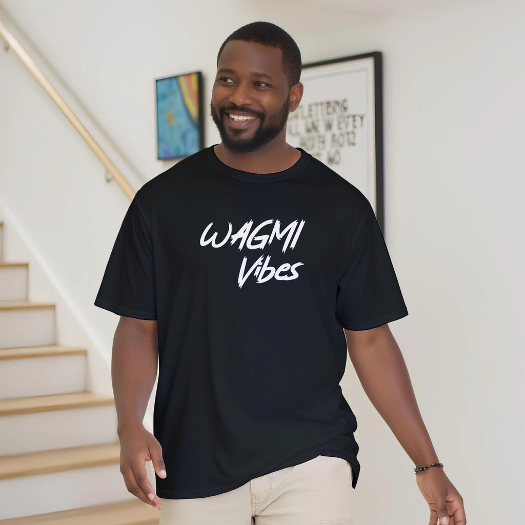 Man wearing a black t-shirt with 'WAGMI Vibes' text, standing indoors.