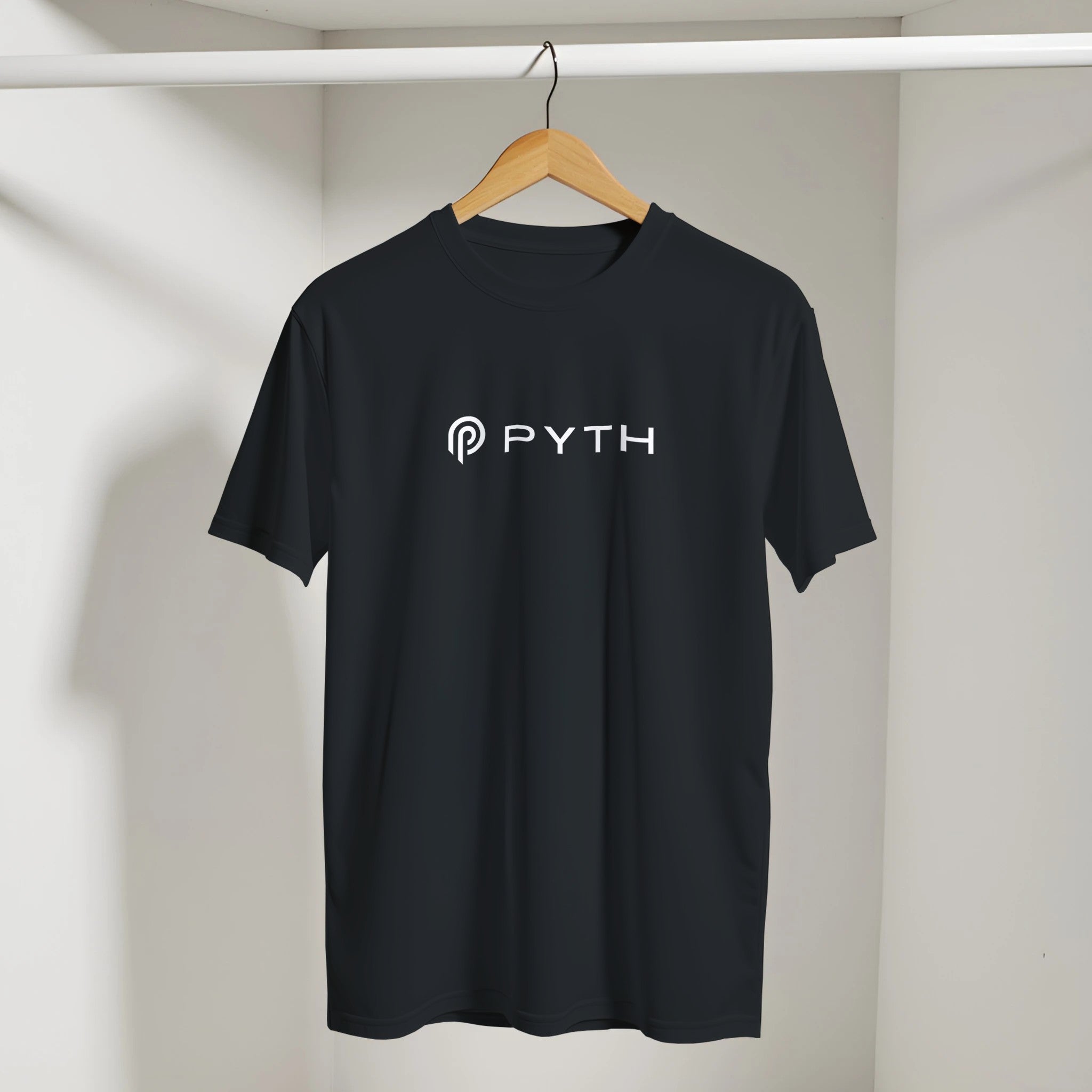 Black t-shirt with 'PYTH' logo on a hanger against a neutral background