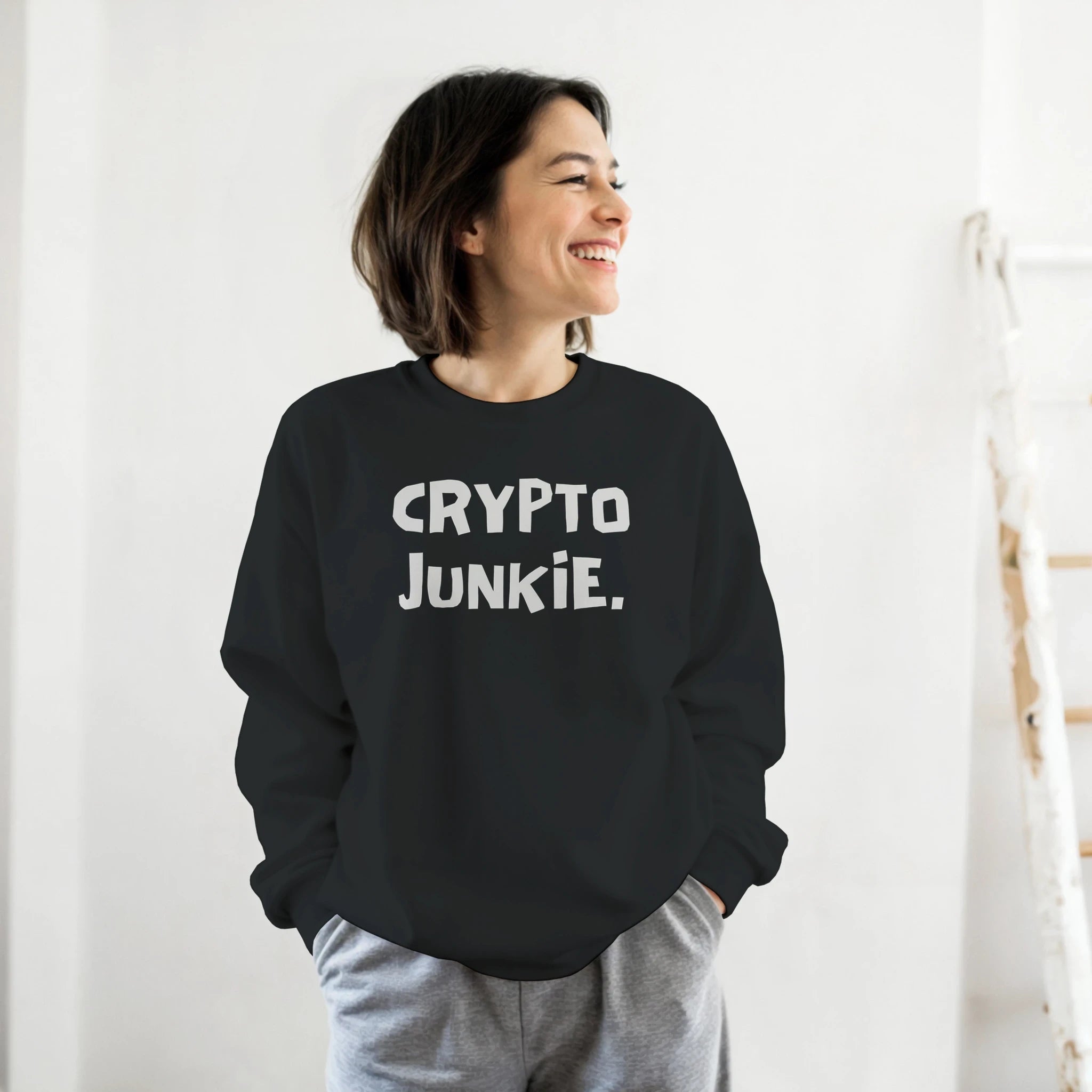 Person wearing a black sweatshirt with 'CRYPTO JUNKIE.' text against a white background