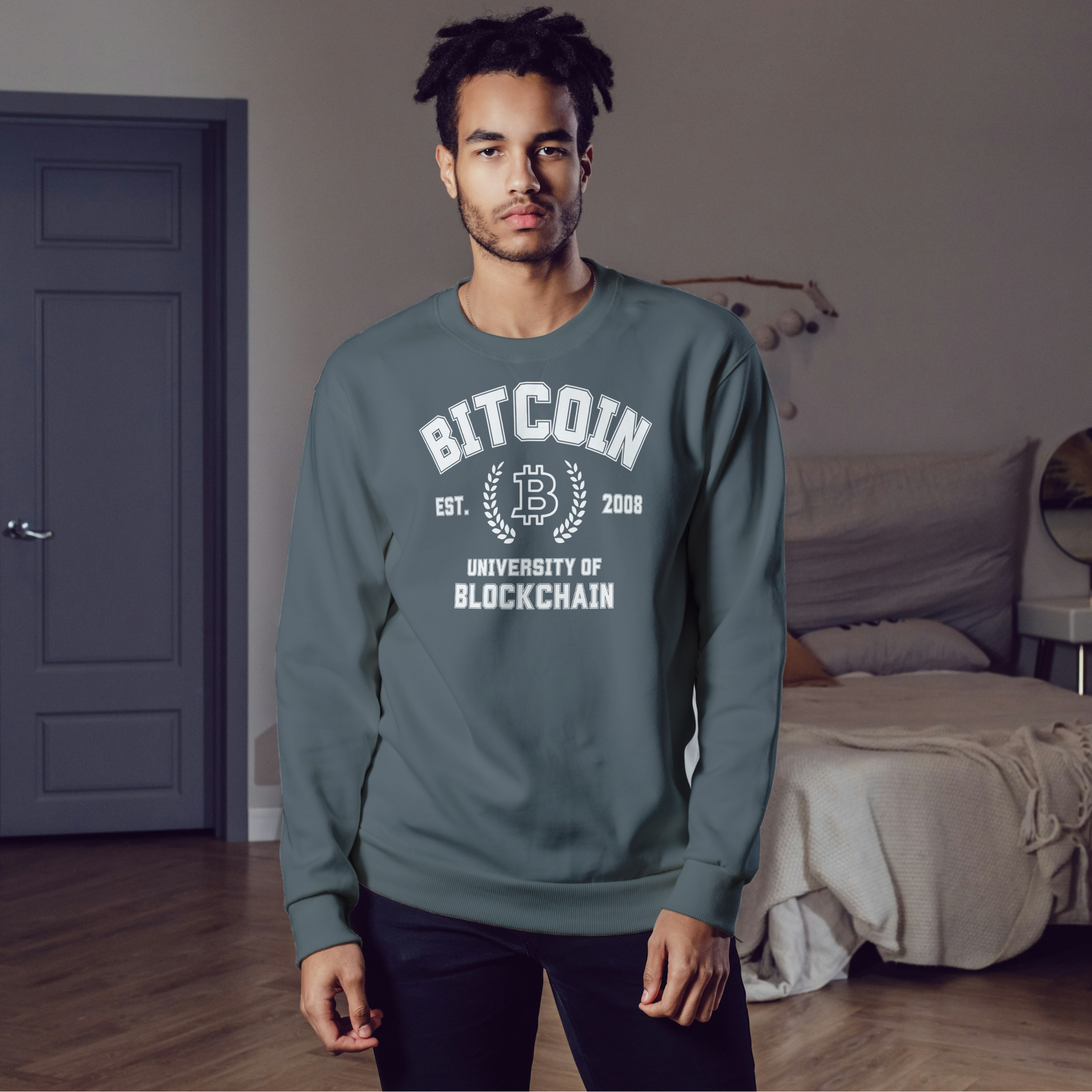 Man wearing a green sweatshirt with 'Bitcoin' text in a room.