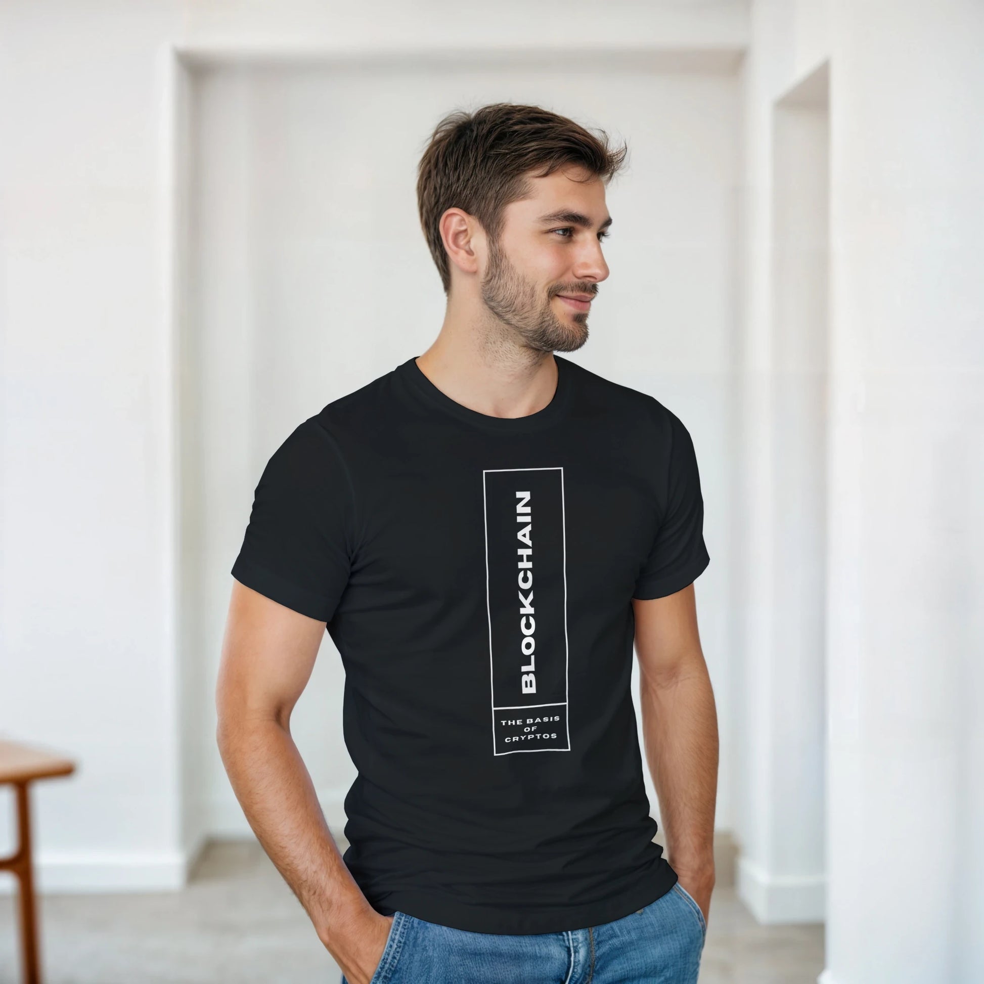 Man wearing a black t-shirt with 'Blockchain' text in a minimal indoor setting