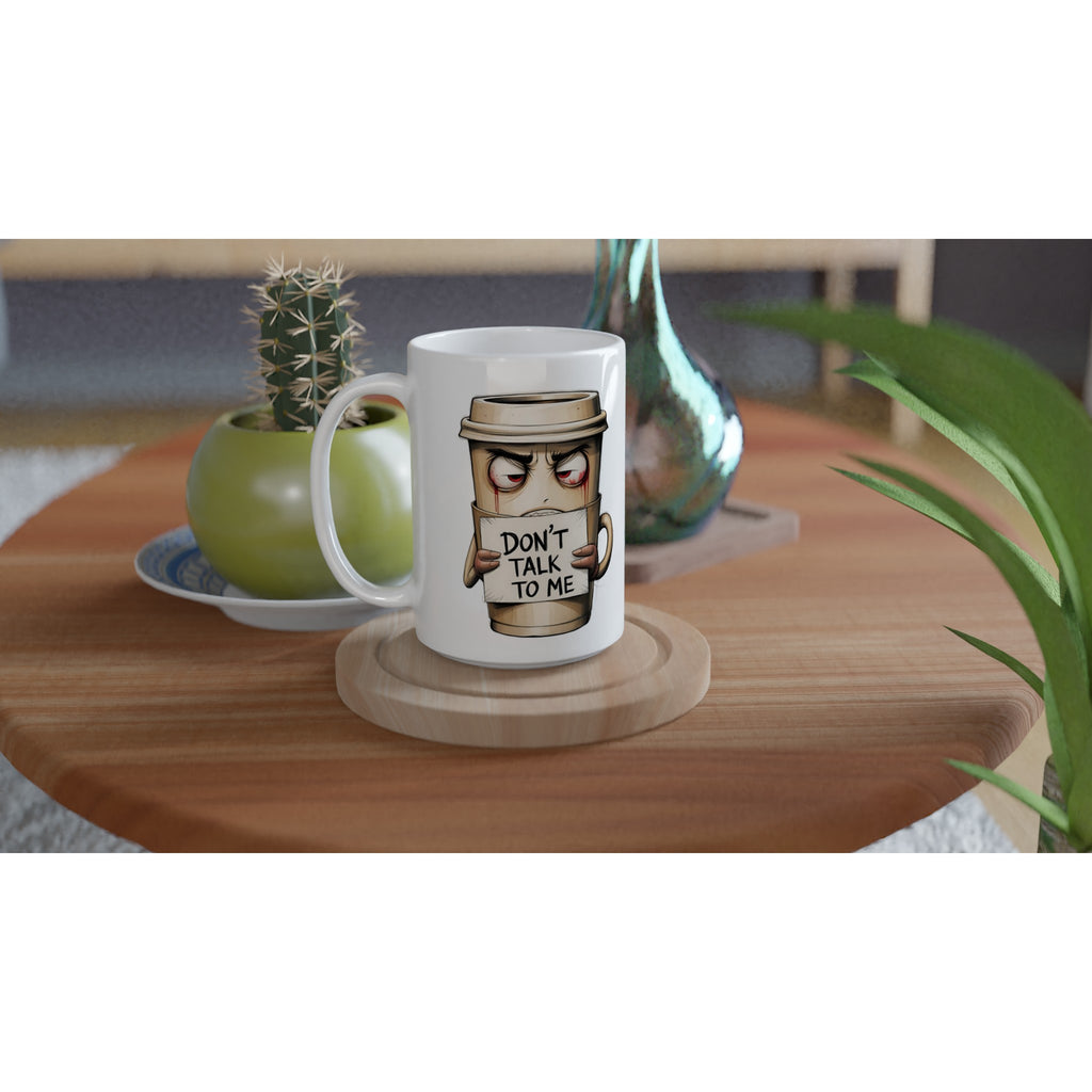 White mug with a coffee cup graphic and 'Don't talk to me' text on a wooden table.