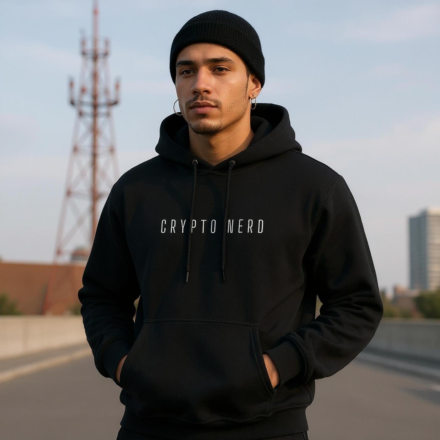 Person wearing a black hoodie with 'CRYPTO NERD' text, standing outdoors.
