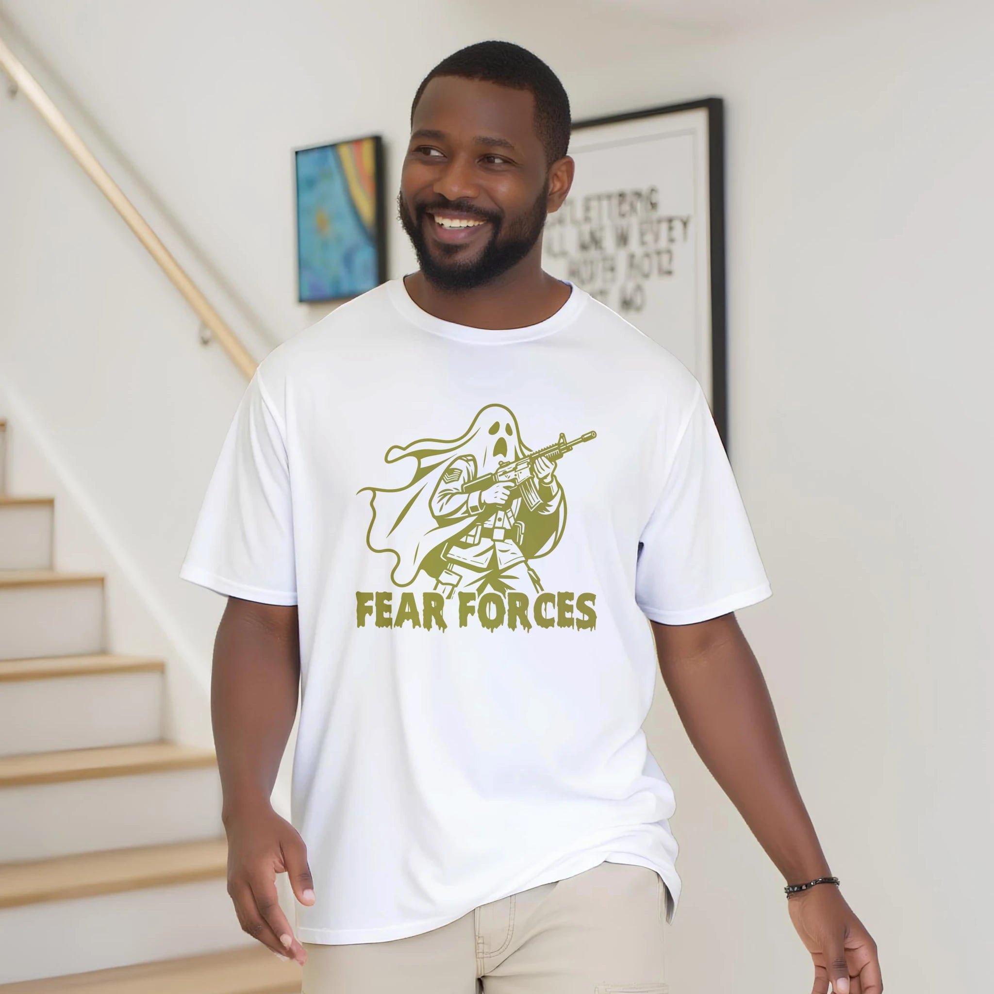 Man wearing a white t-shirt with a graphic design and text indoors.