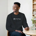 Man wearing a black sweatshirt with 'PYTH' logo sitting in a room.