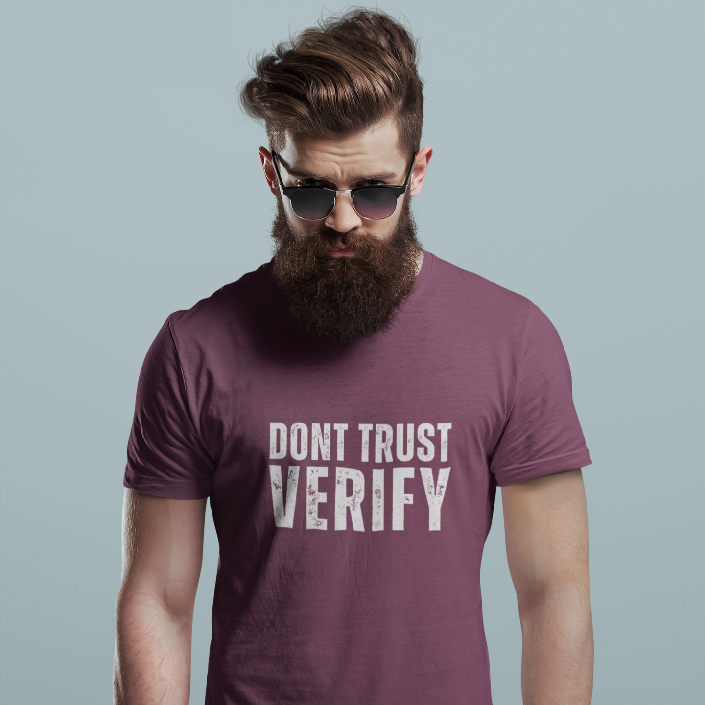 Man wearing a purple t-shirt with 'DON'T TRUST VERIFY' text against a plain background