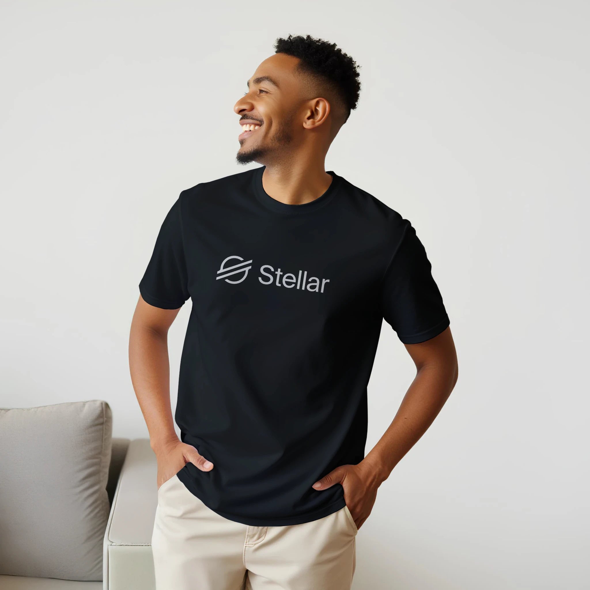 Man wearing a black t-shirt with 'Stellar' logo against a light background