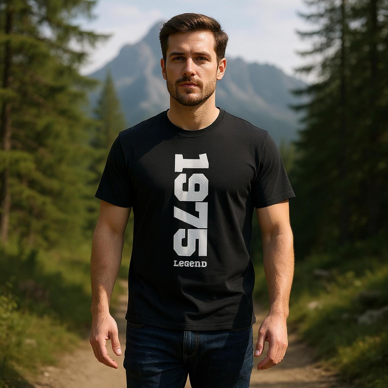 Man wearing a black t-shirt with '1975 Legend' text in a forest setting