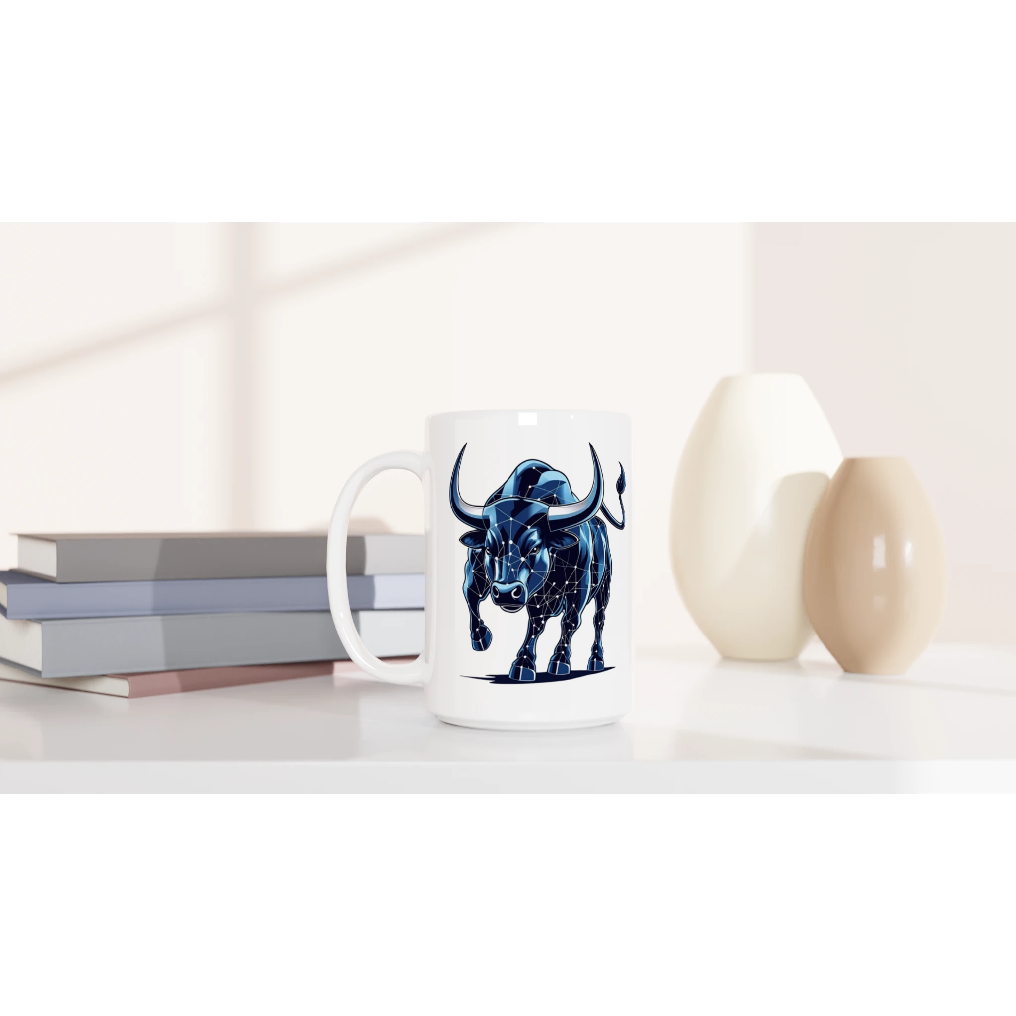 Mug with a blue bull design on a white surface with books and decorative items.