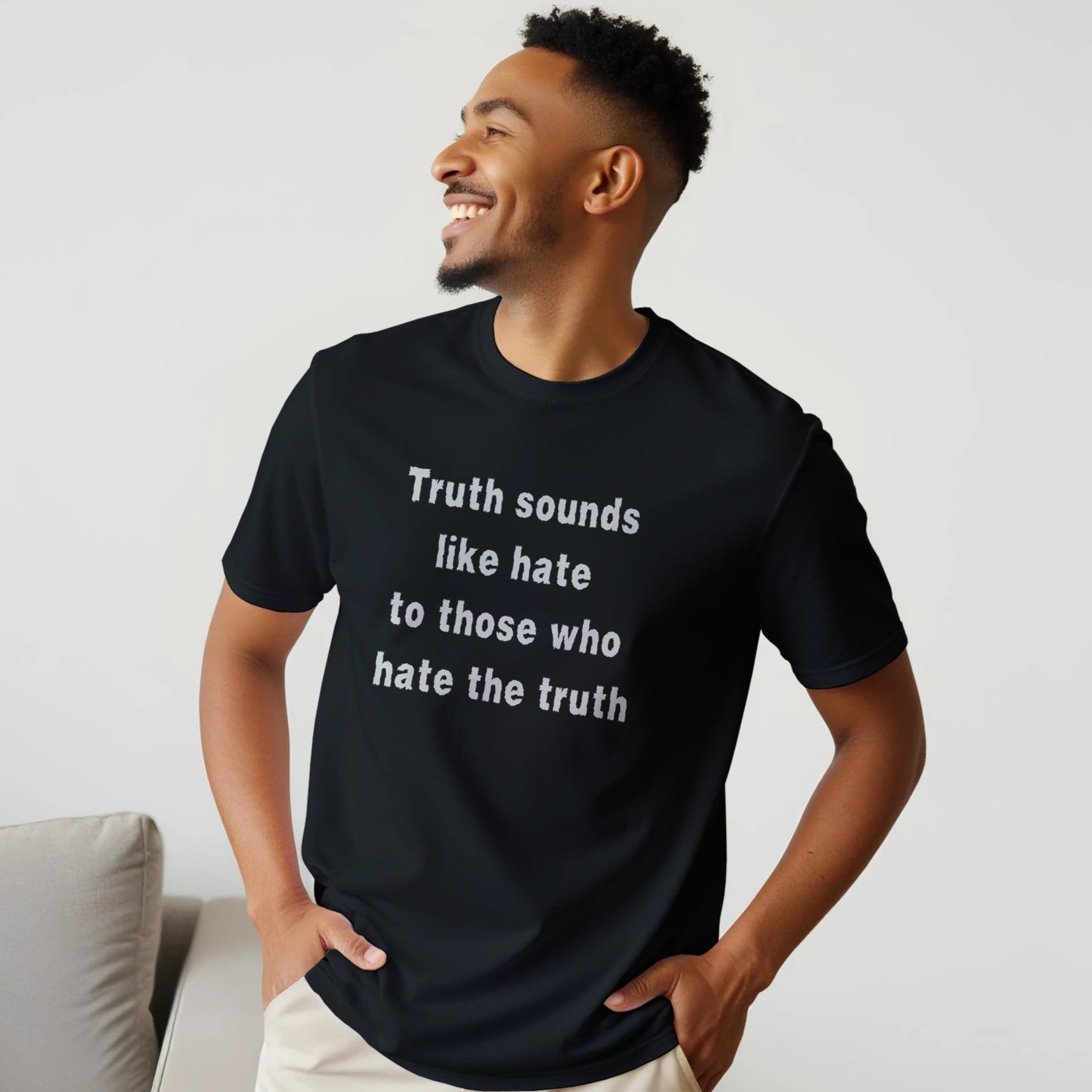 Man wearing a black t-shirt with text, standing against a plain background