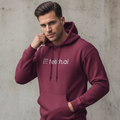 Man wearing a maroon hoodie with 'fetch.ai' logo against a concrete wall.