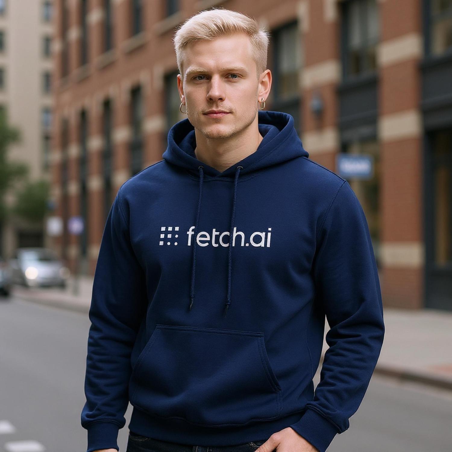 Person wearing a navy blue hoodie with 'fetch.ai' logo on a city street.