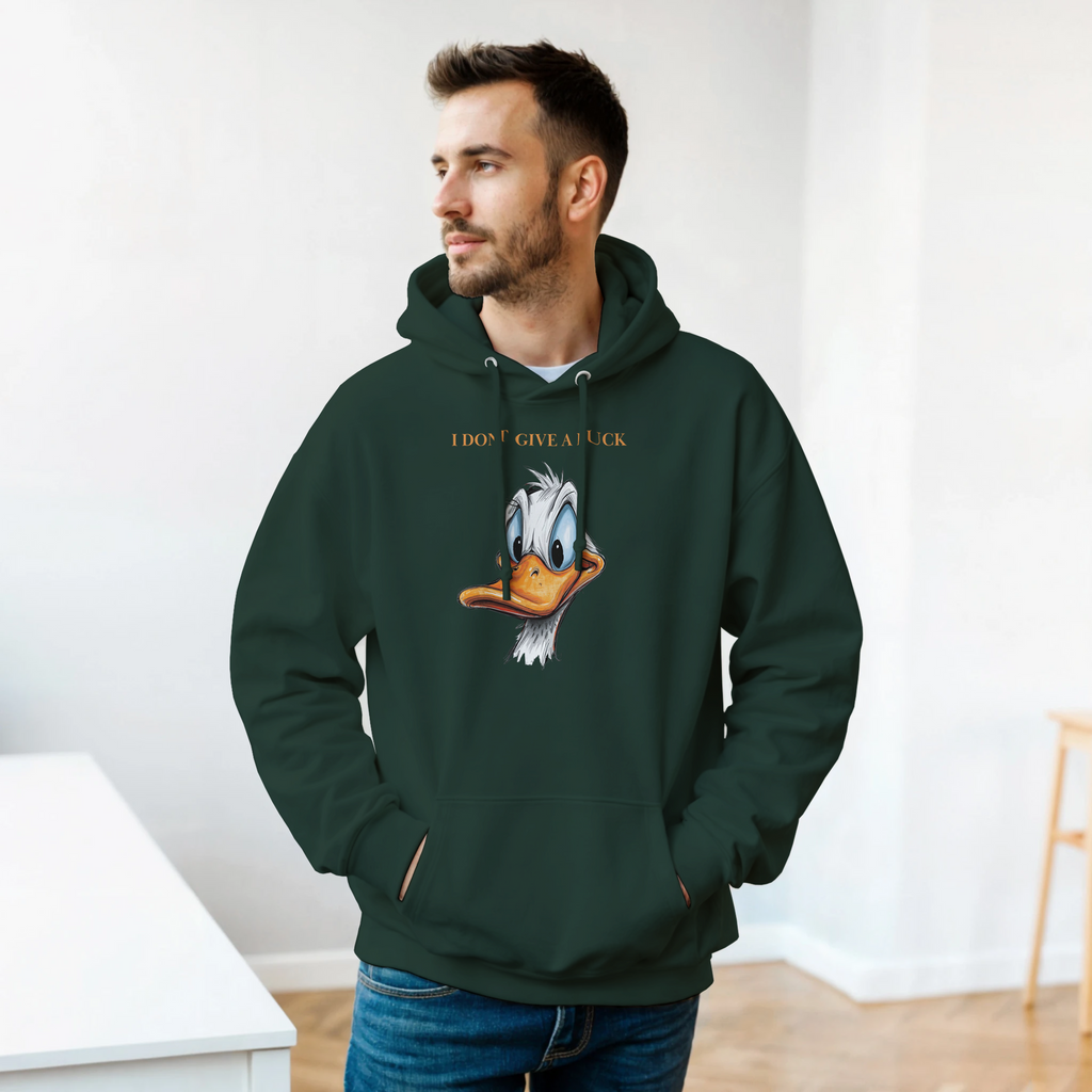 Man wearing a green hoodie with a cartoon character design indoors.