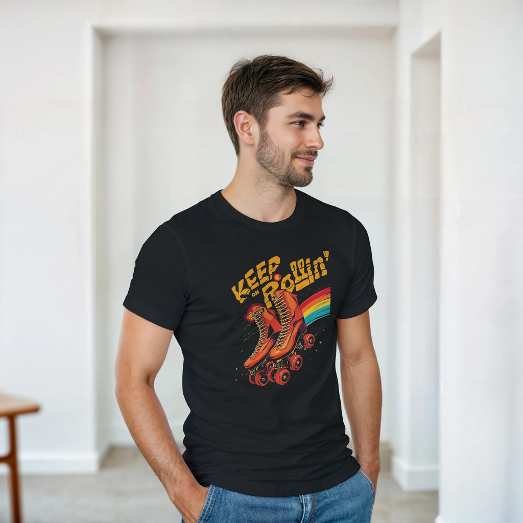 Man wearing a black t-shirt with a colorful graphic and text, standing in a minimalistic room.