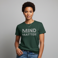 Person wearing a green t-shirt with 'MIND MATTER' text on a gray background
