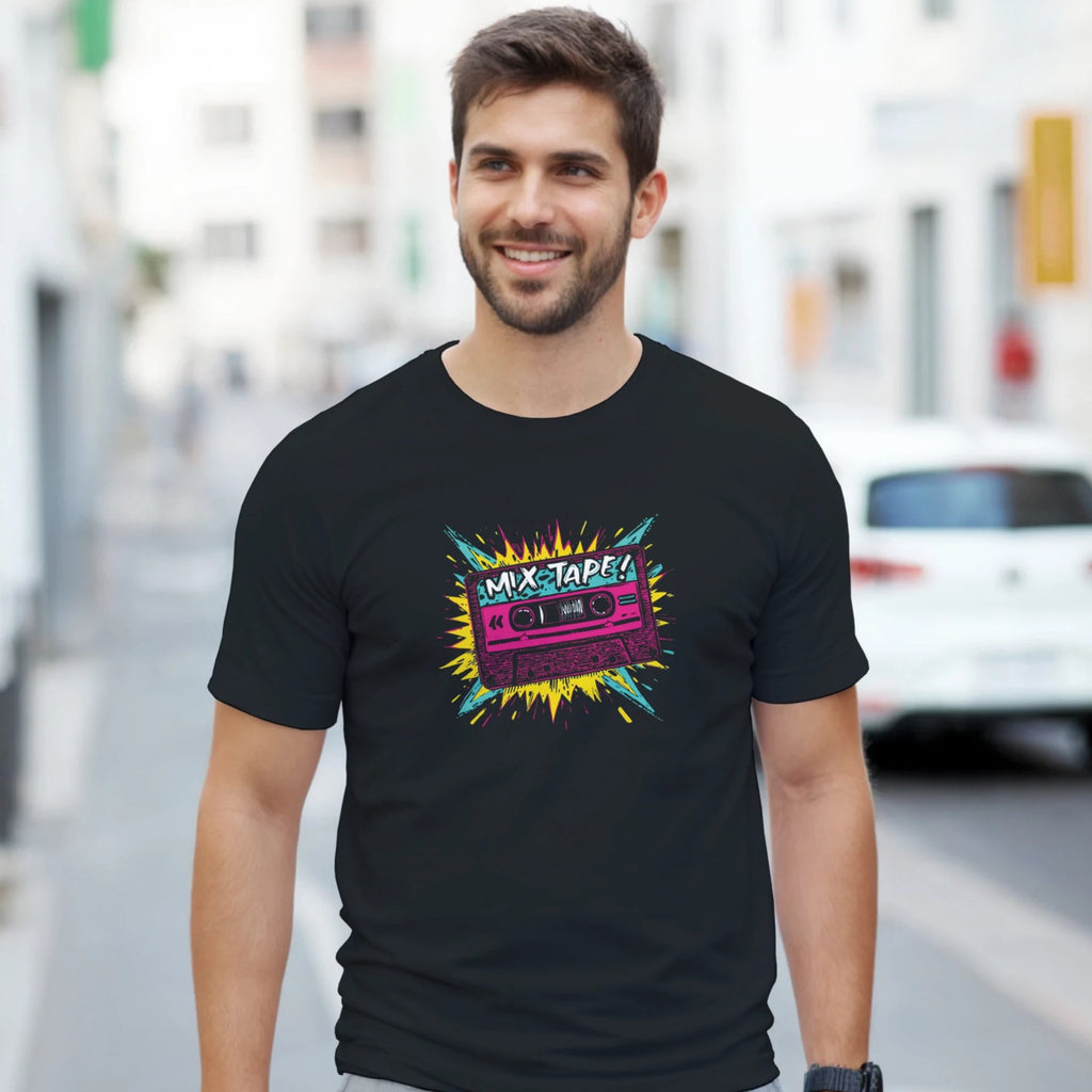 Man wearing a black t-shirt with a colorful graphic design on a city street.