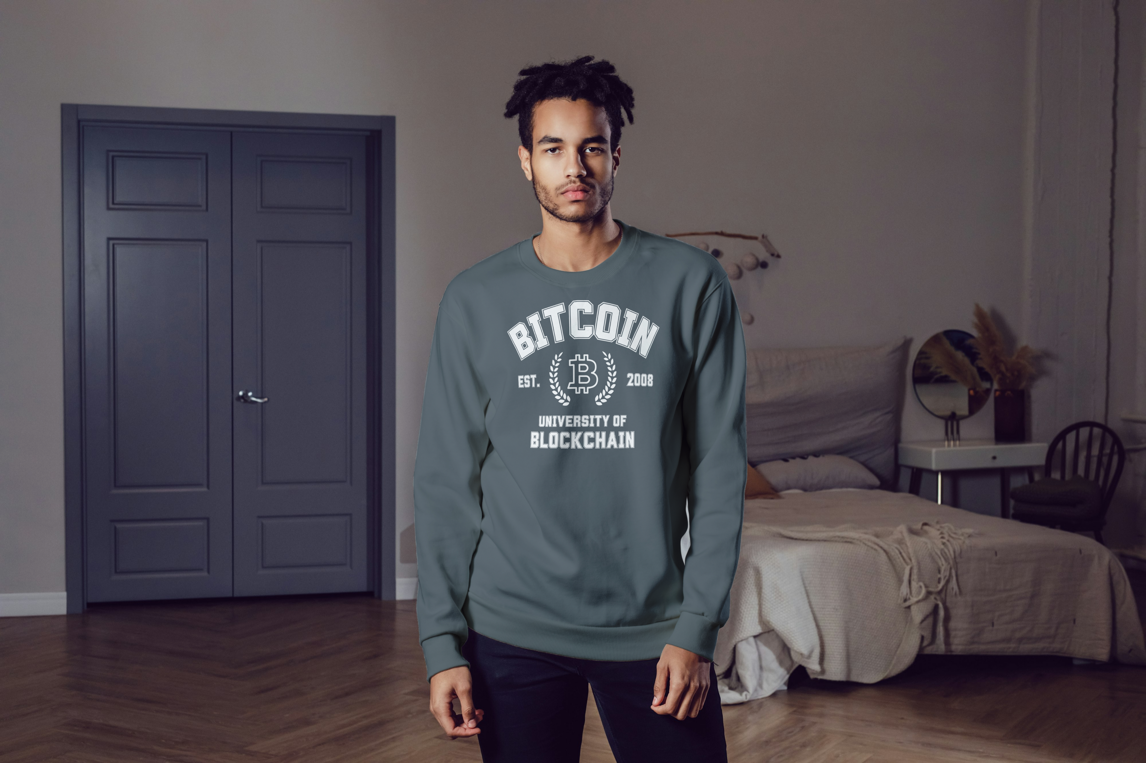 Man wearing a green sweatshirt with 'Bitcoin' text in a room.
