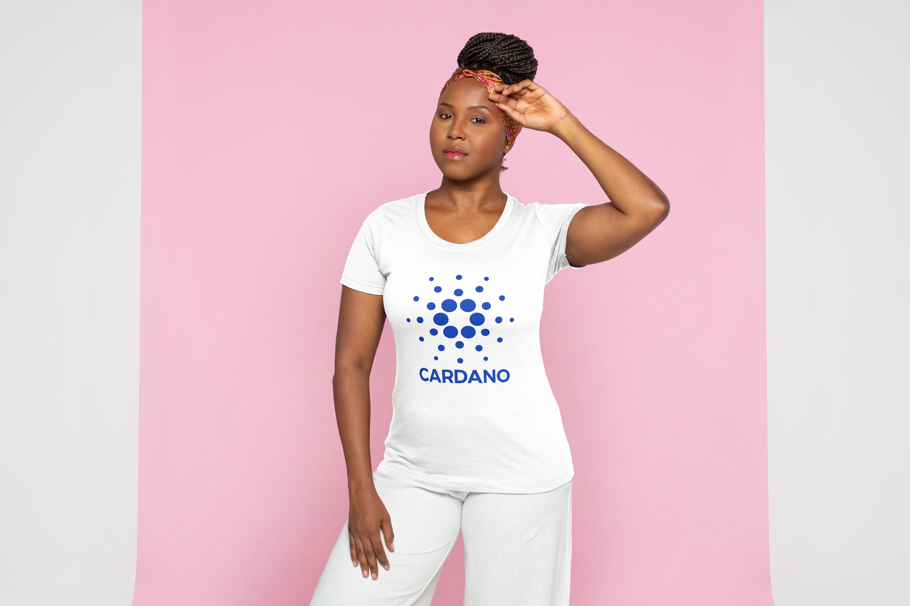 Woman wearing a white t-shirt with Cardano logo on a pink background