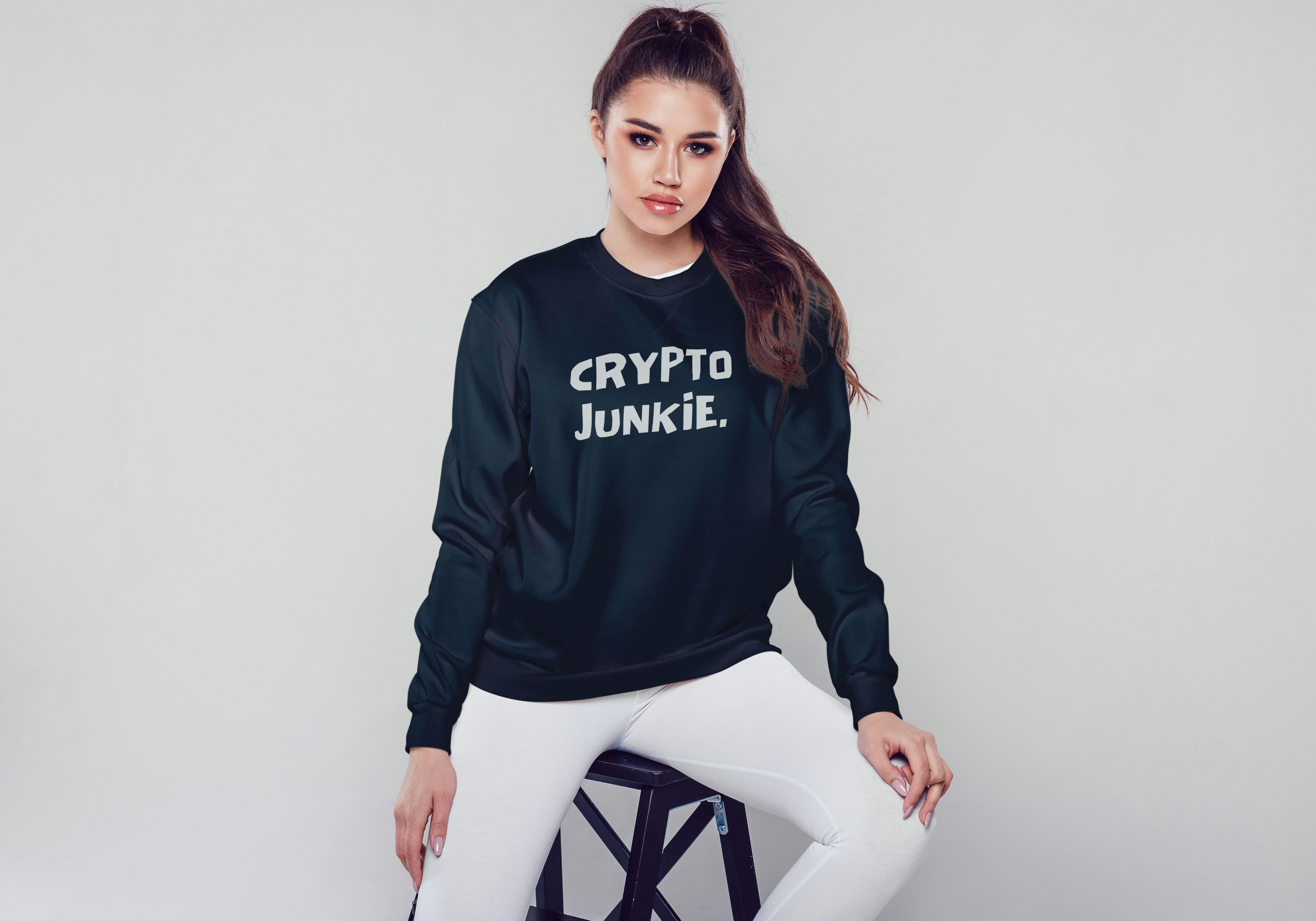 Person wearing a black sweatshirt with 'CRYPTO JUNKIE' text on a white background