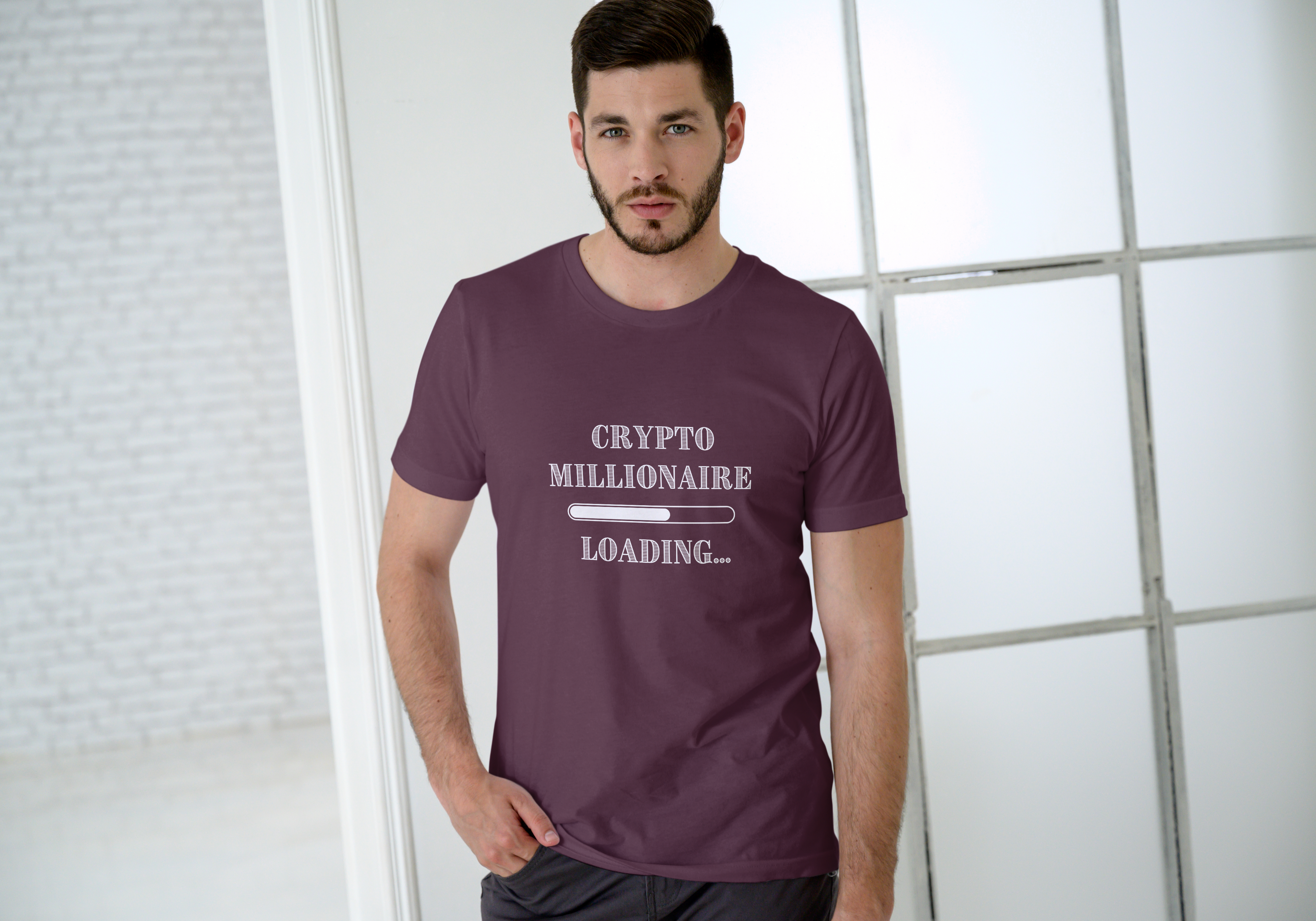 Man wearing a purple t-shirt with 'Crypto Millionaire Loading' text in a modern indoor setting.