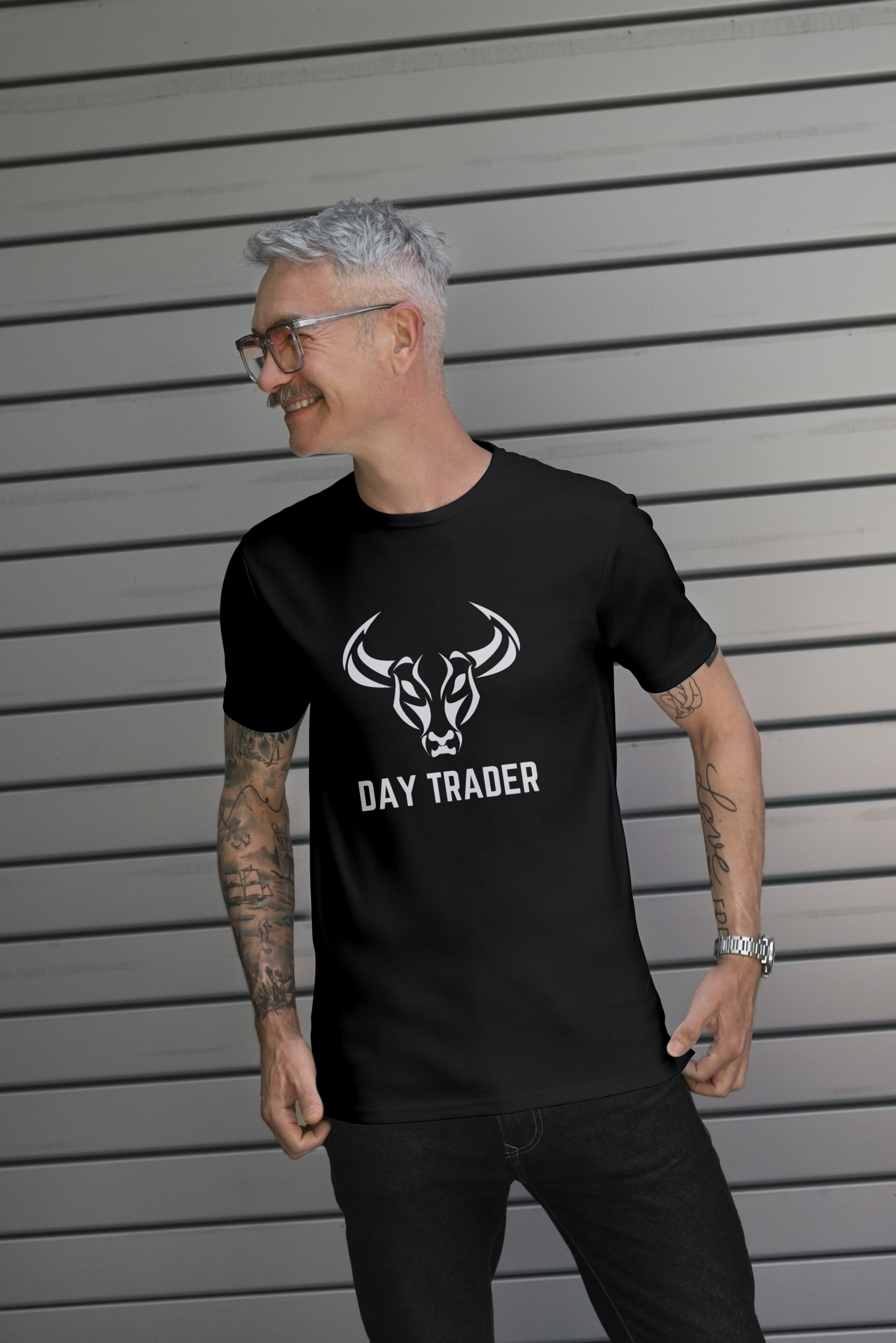 Man wearing a black t-shirt with a logo and text, standing against a gray background