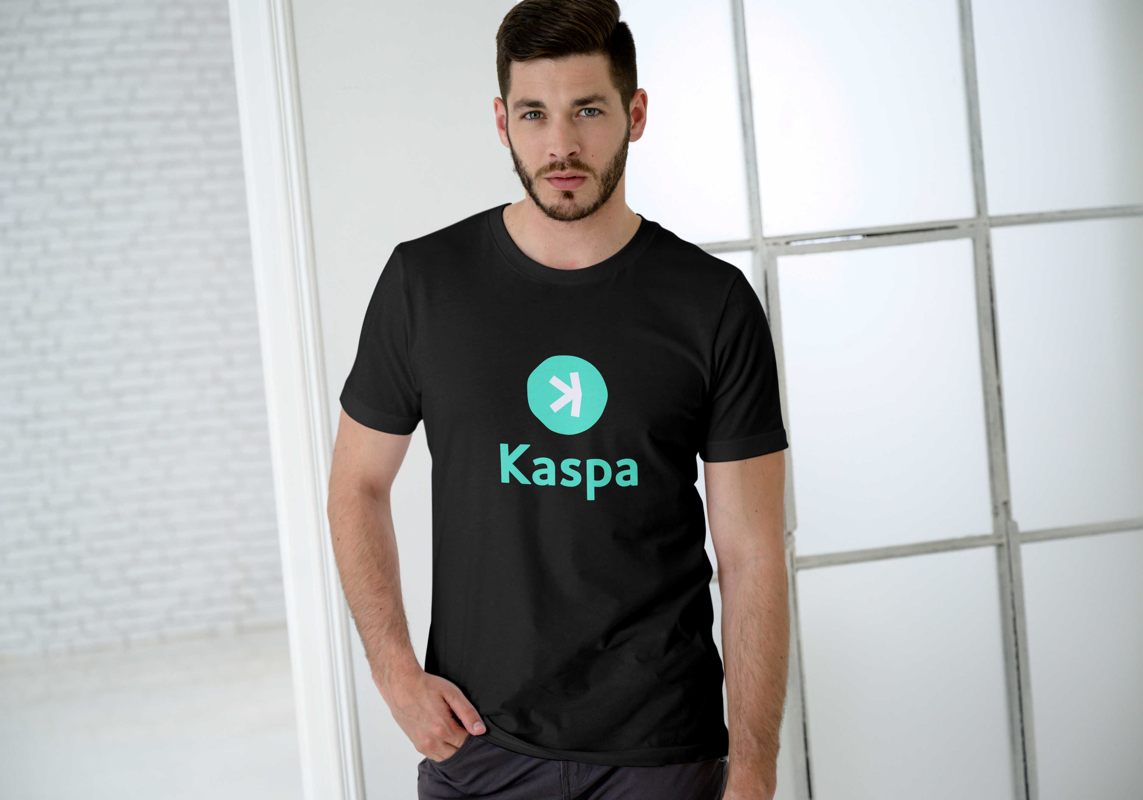 Person wearing a black t-shirt with Kaspa logo against a light background