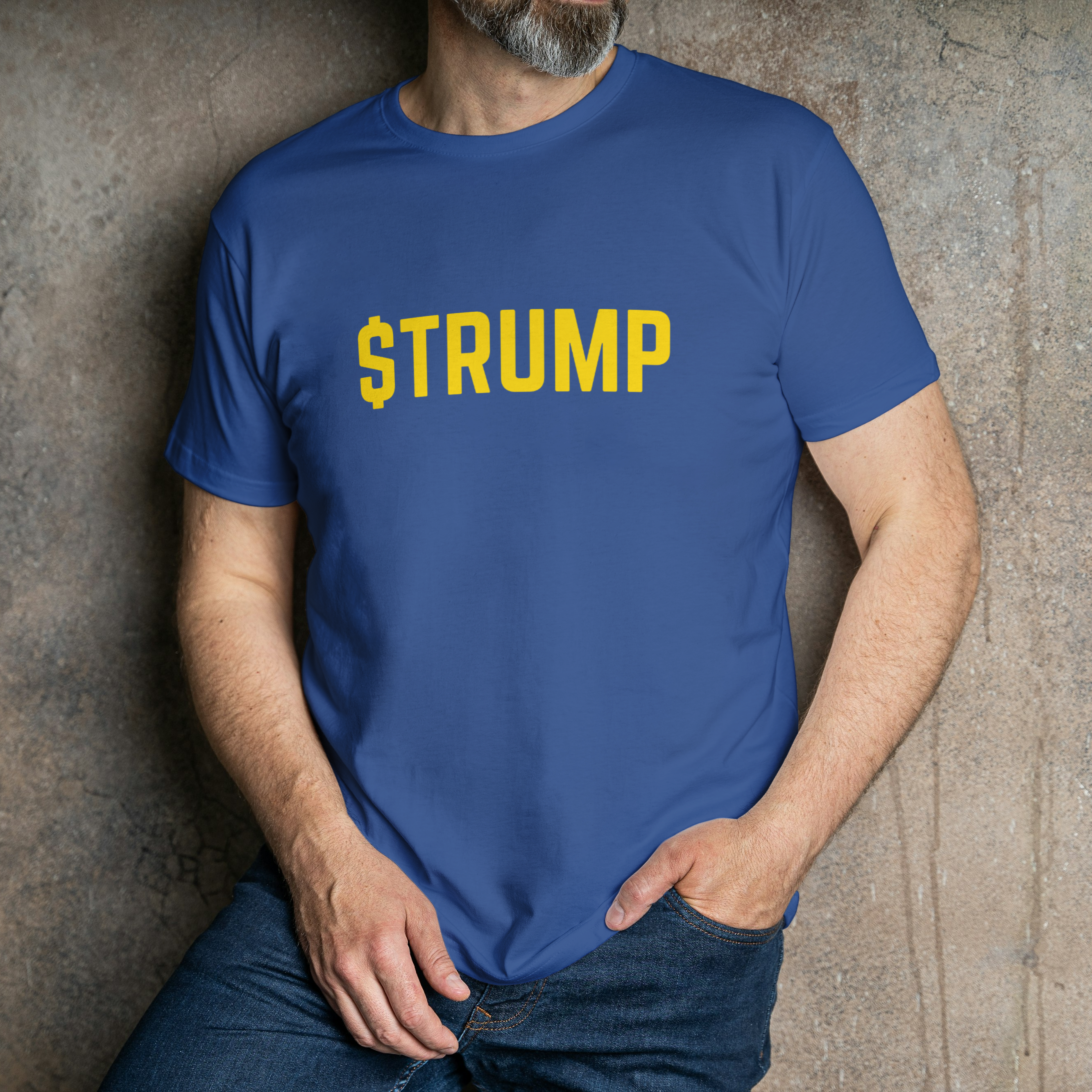 Person wearing a blue t-shirt with 'STRUMP' printed in yellow against a textured wall.