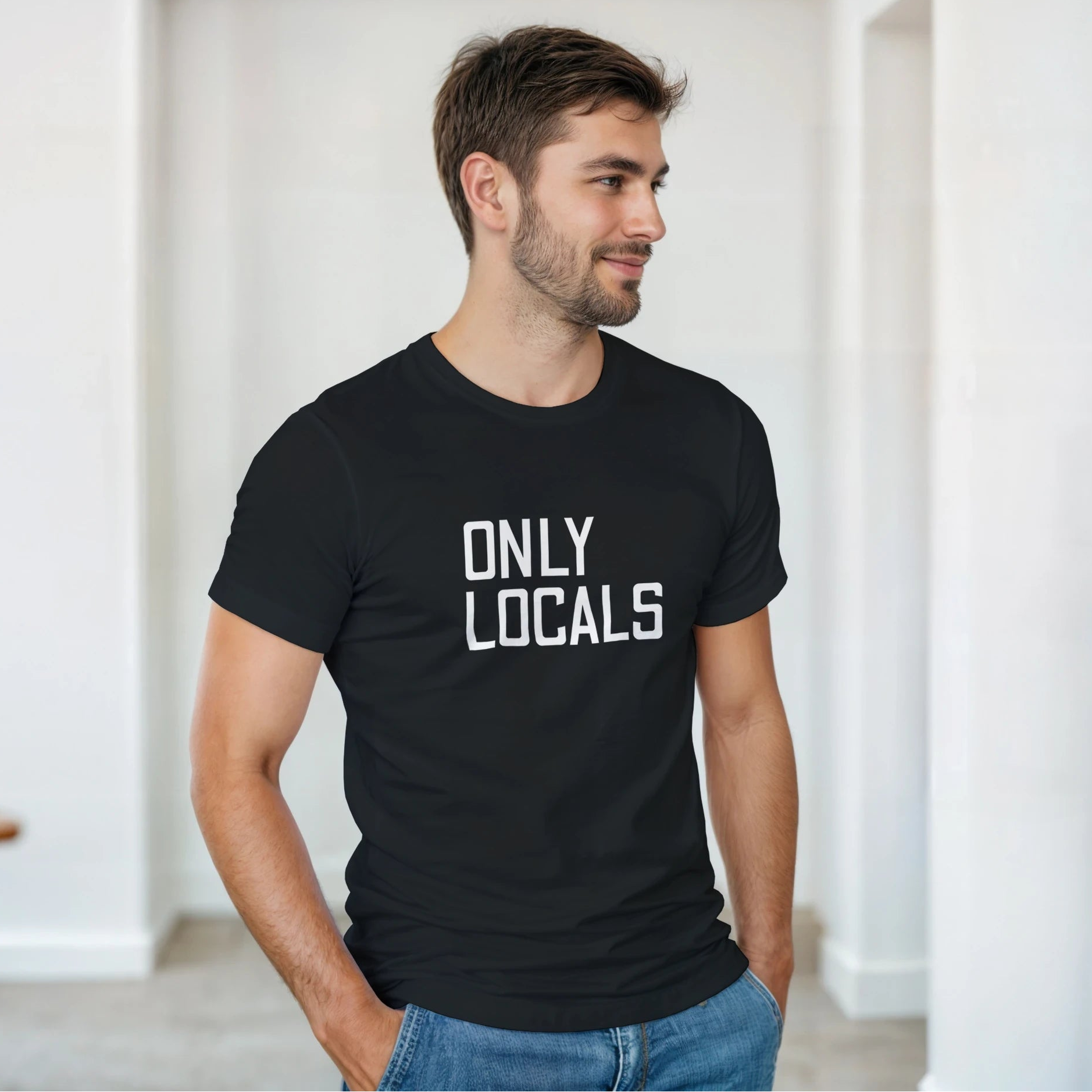 Man wearing a black t-shirt with 'ONLY LOCALS' text in a minimal indoor setting