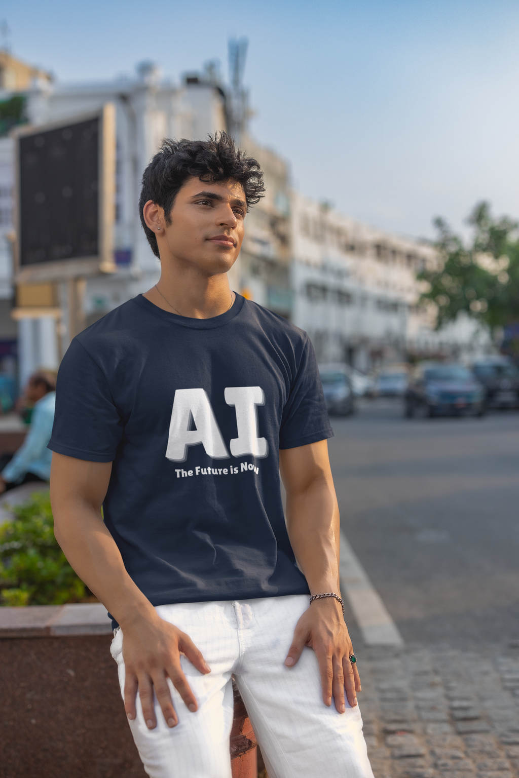 Man wearing a navy blue t-shirt with 'AI The Future is Now' text on a city street.